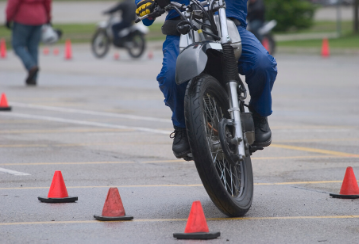 Motorcycle navigating pylons in a parking lot