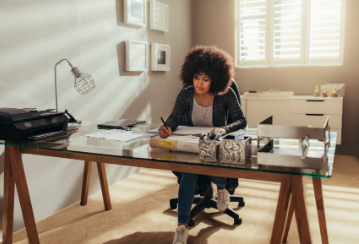 Woman sitting at a desk in a home office.